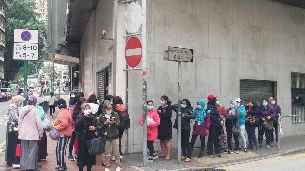 Indonesian citizens queue for free masks at the Indonesian Consulate General in Hong Kong.