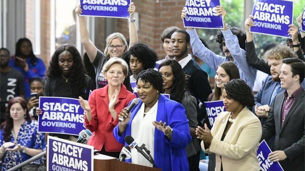 Stacey Abrams speaks to supporters, joined by Boston City Councilwoman Ayanna Presseley (R) and Democratic Senator Elizabeth Warren of Massachusetts.