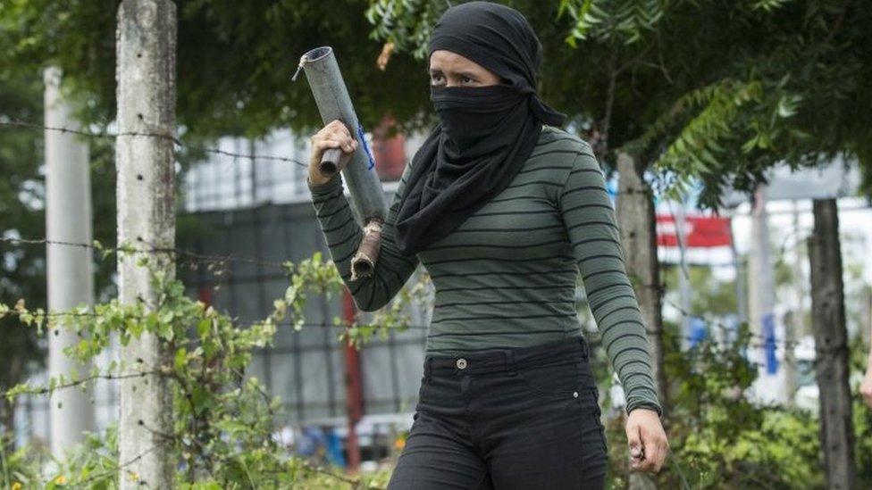 A woman with homemade mortars participate in a sit-in called "Human Chain from Rotunda to Rotunda", at a distance of 3.4 km on the road to Masaya, in Managua, Nicaragua, 04 July 2018.