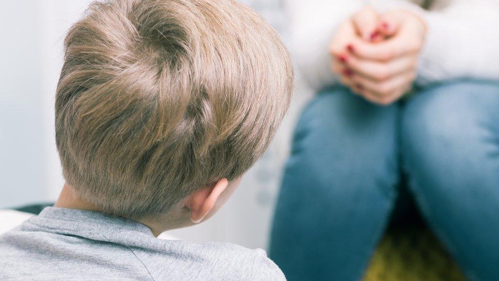 Boy talking to adult