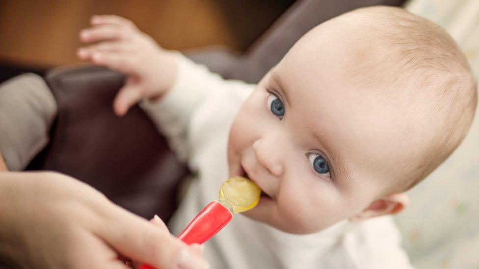 Baby being fed