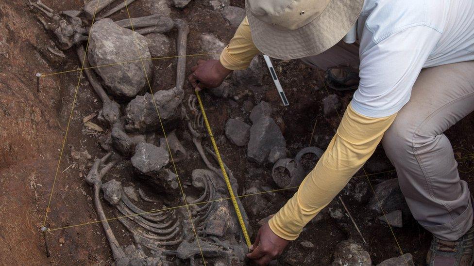 An archaeologist of the Pacopampa Archaeological Project works on the site of the 3,000-year-old tomb