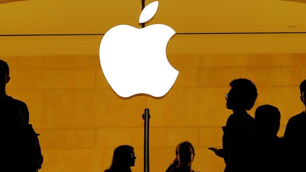 Customers walk past an Apple logo inside of an Apple store at Grand Central Station in New York, U.S., August 1, 2018.