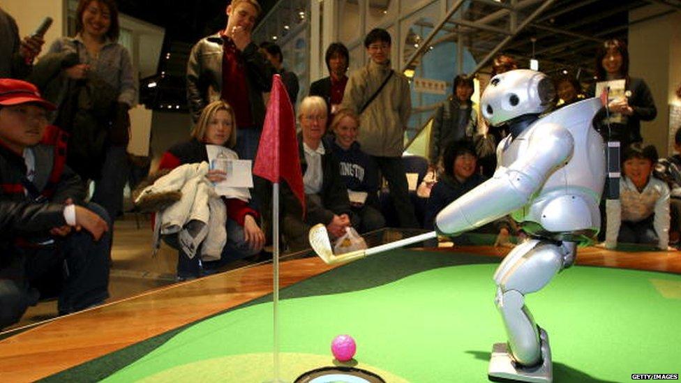 Sony's walking robot, Qrio plays golf in 2004