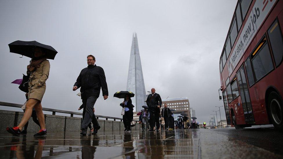 Commuters head into the City of London across London Bridge, 27 June