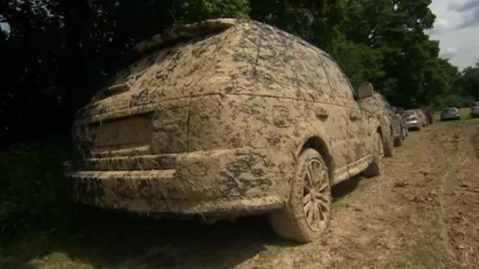 Muddy cars in a field