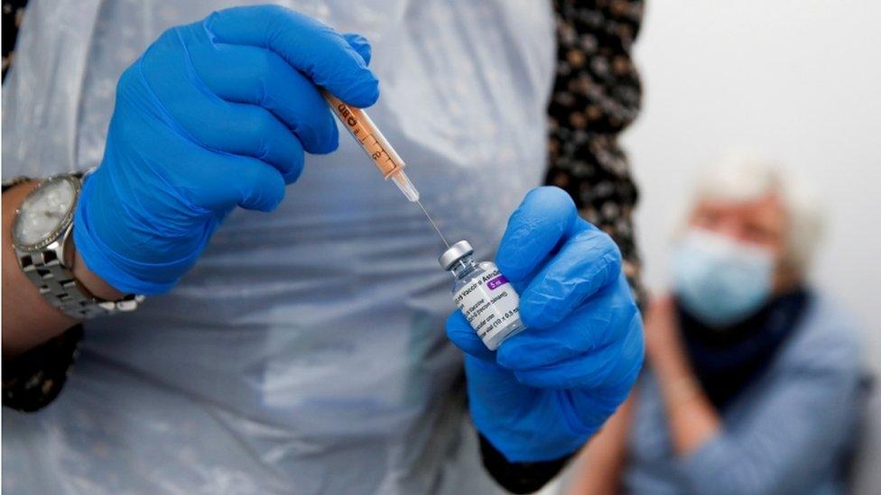 A health worker prepares to administer Oxford-AstraZeneca Covid-19 vaccine