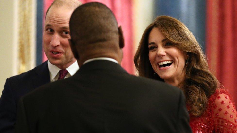 The Duke and Duchess of Cambridge speak to a guest at their evening reception at Buckingham Palace