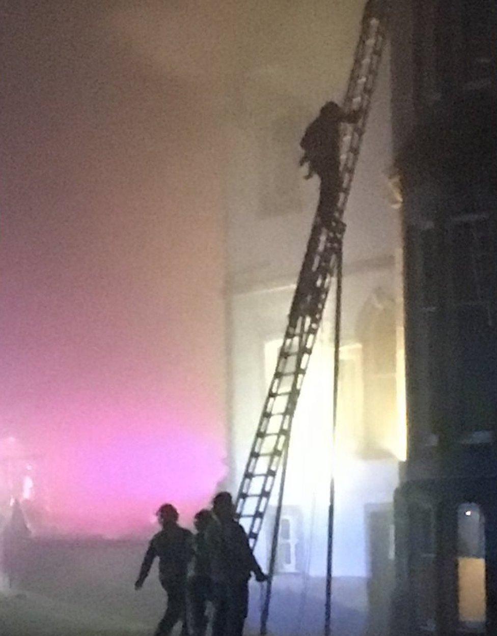 Baby being rescued from hotel fire