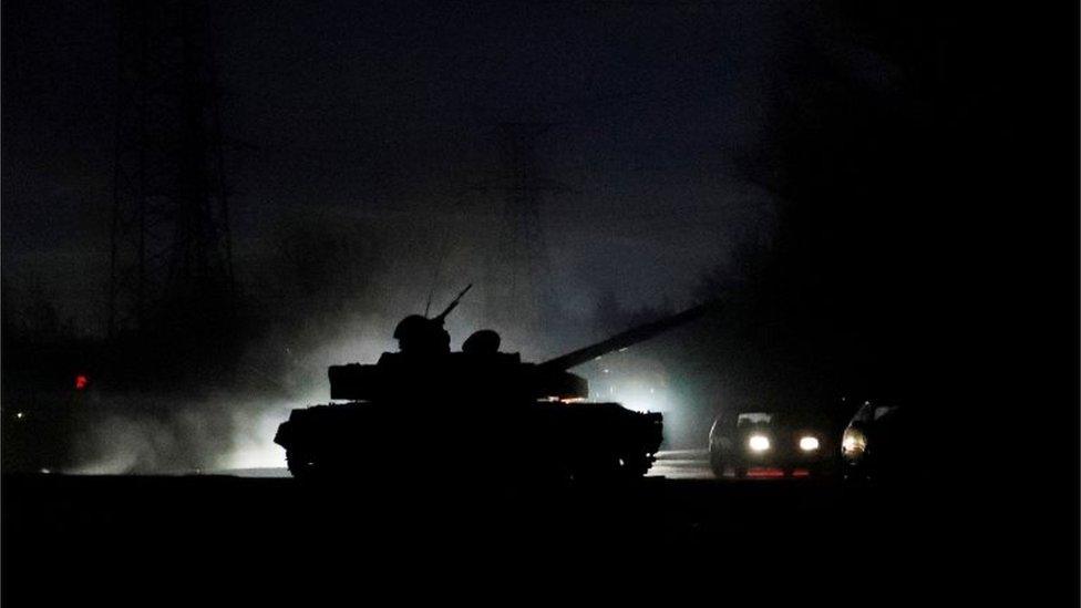 A Russian tank drives along a street in Donetsk