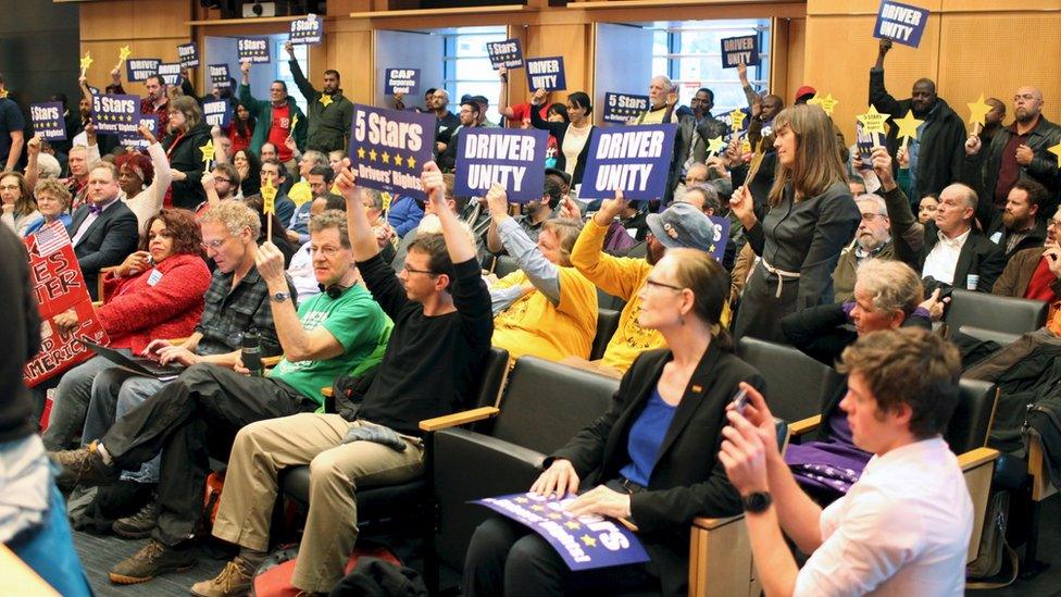 Supporters cheer during a meeting when the Seattle City Council voted to approve a measure that would allow ride sharing drivers for Uber and Lyft to unionize in Seattle, Washington on 14 December.