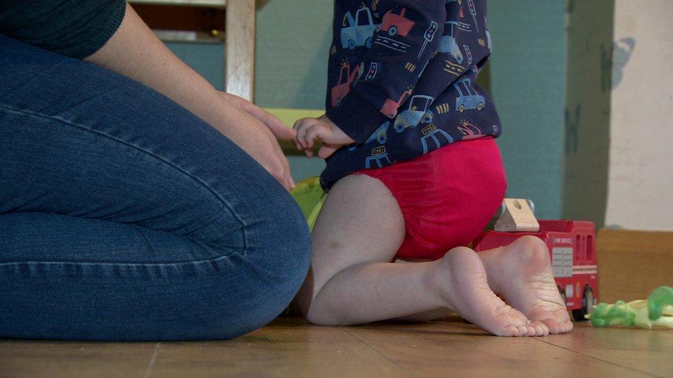 Karen McKenna and her child using the reusable nappy