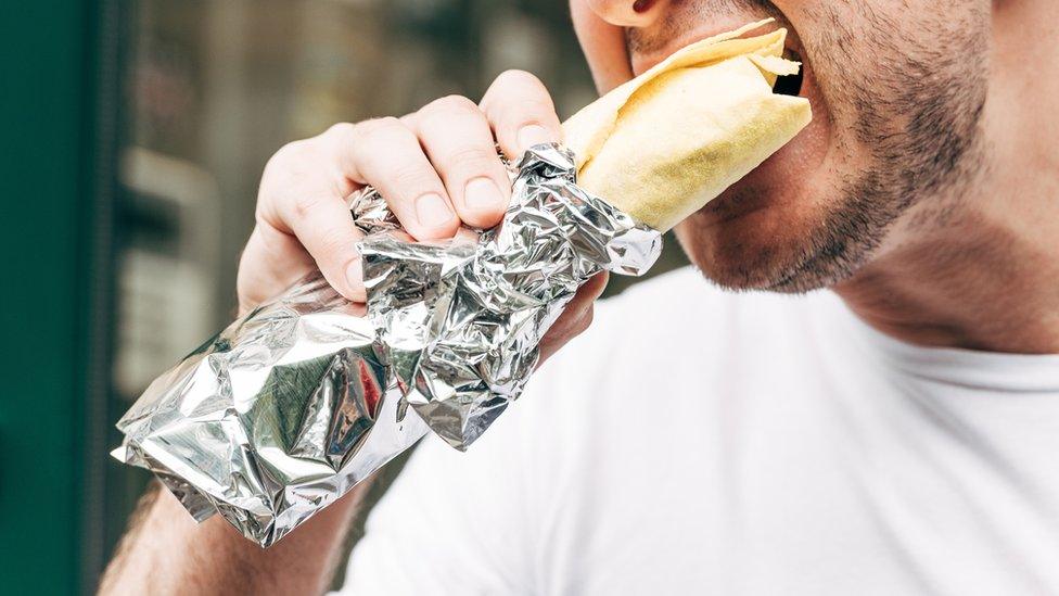 Person eating a kebab