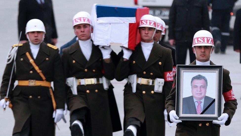 Members of a Turkish forces honour guard carry the Russian flag-draped coffin of late Russian Ambassador to Turkey Andrei Karlov