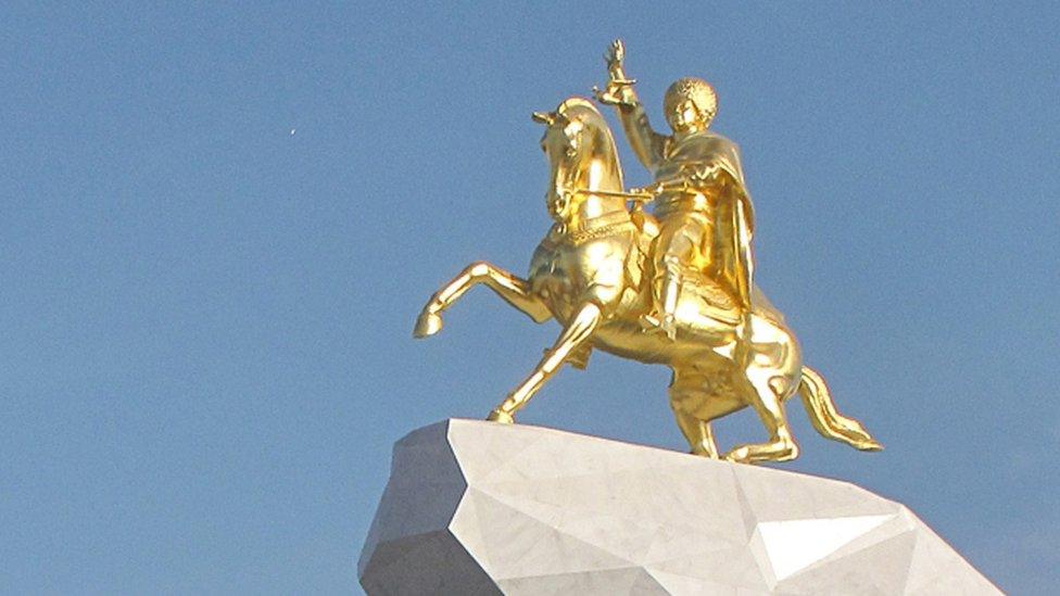 A golden monument of Turkmenistan's President Berdymukhamedov on horseback in Ashgabat