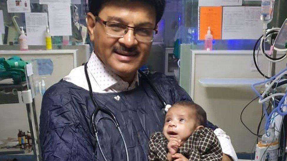 Dr Ravi Khanna with the baby in his hospital