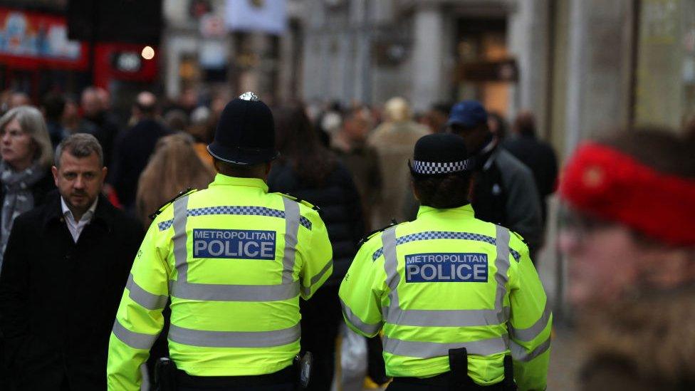 Two police officers, walking away