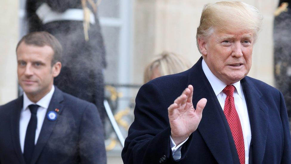 US President Donald Trump (R) waves as he leaves the Elysee Palace in Paris on November 10, 2018