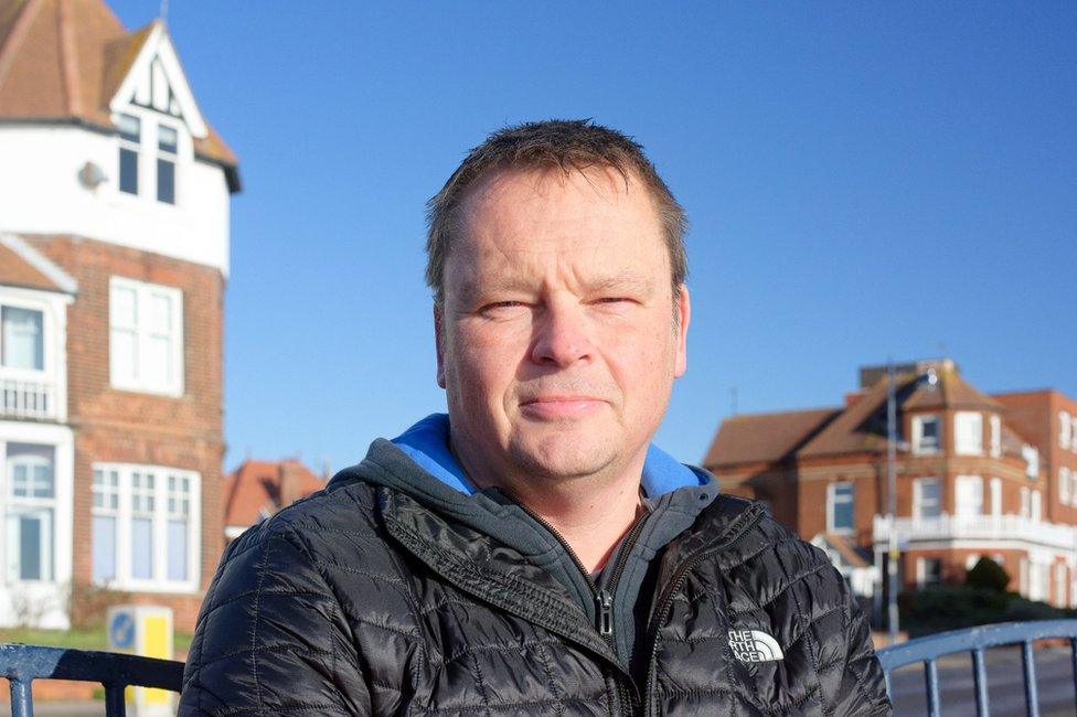 Darren Aitchison in front of buildings at Felixstowe