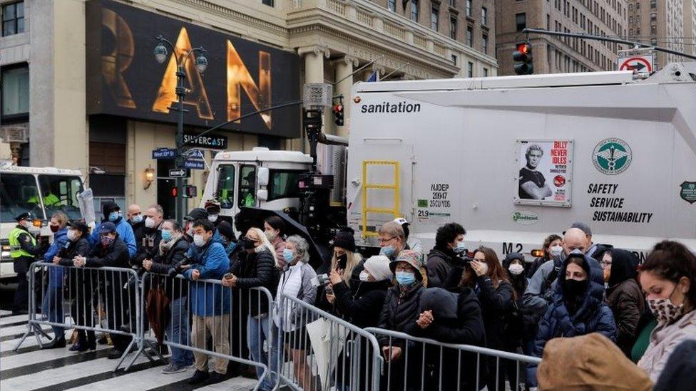 People look on from behind a fence during the 94th Macy's Thanksgiving Day Parade in New York. Photo: 26 November 2020