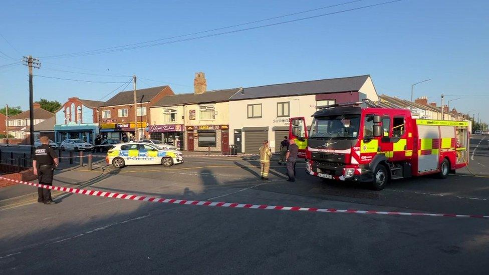 A fire engine and police cordon at the scene