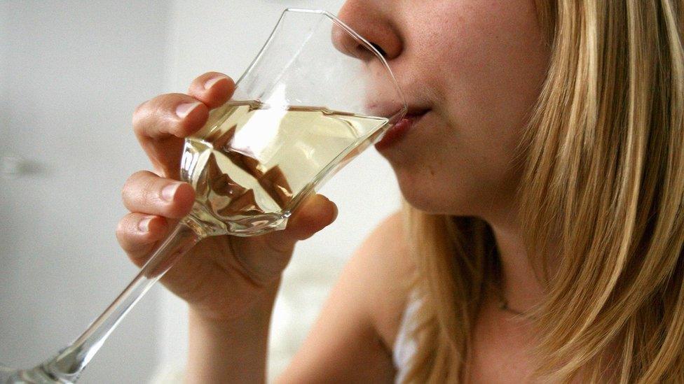 Woman drinking a glass of wine