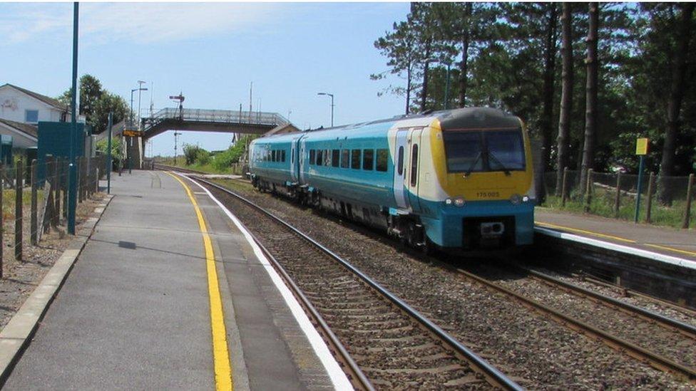 A photo of an Arriva train at Ferryside.