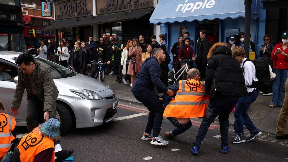 Protesters being dragged away by members of the public