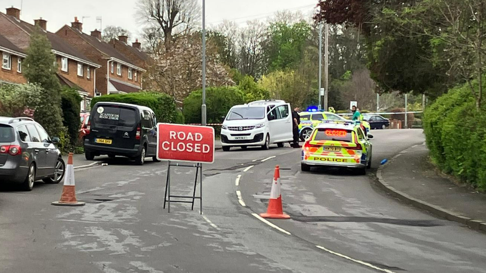 A road closed sign in Bristol with a police car