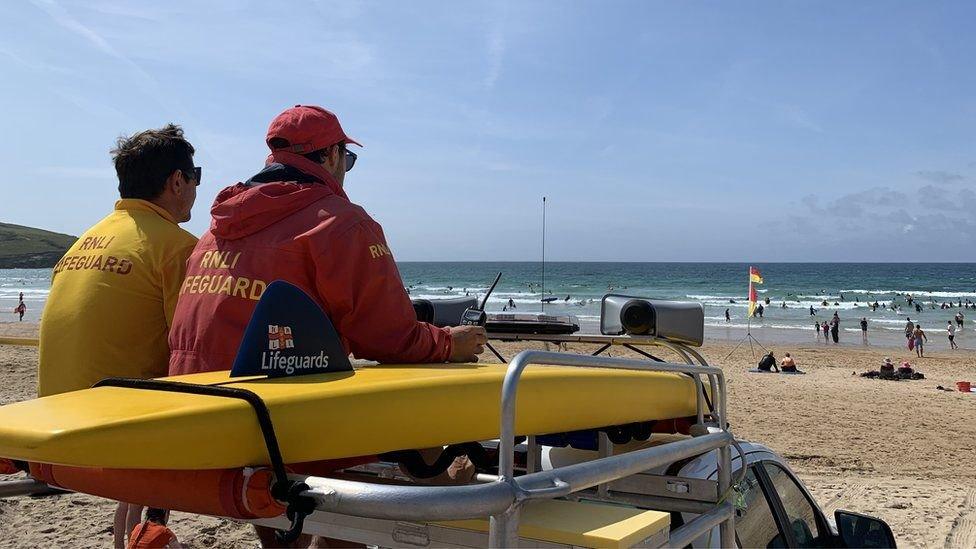 RNLI lifeguards patrolling a beach