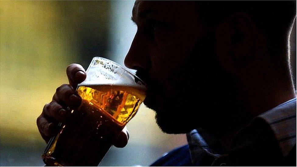 Man drinking a pint of lager