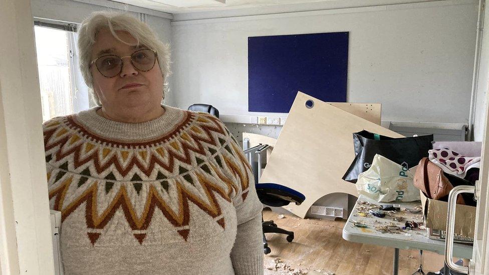 A woman in a school wrecked by a flood