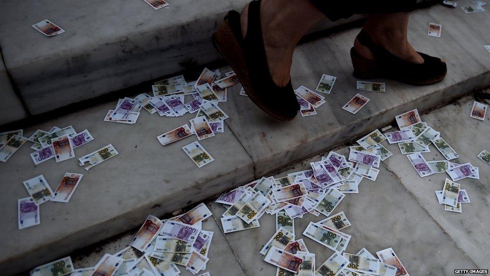 Fake euro notes are thrown on the ground during a pro-European demonstration in front of the Greek parliament in Athens on 22 June 2015.