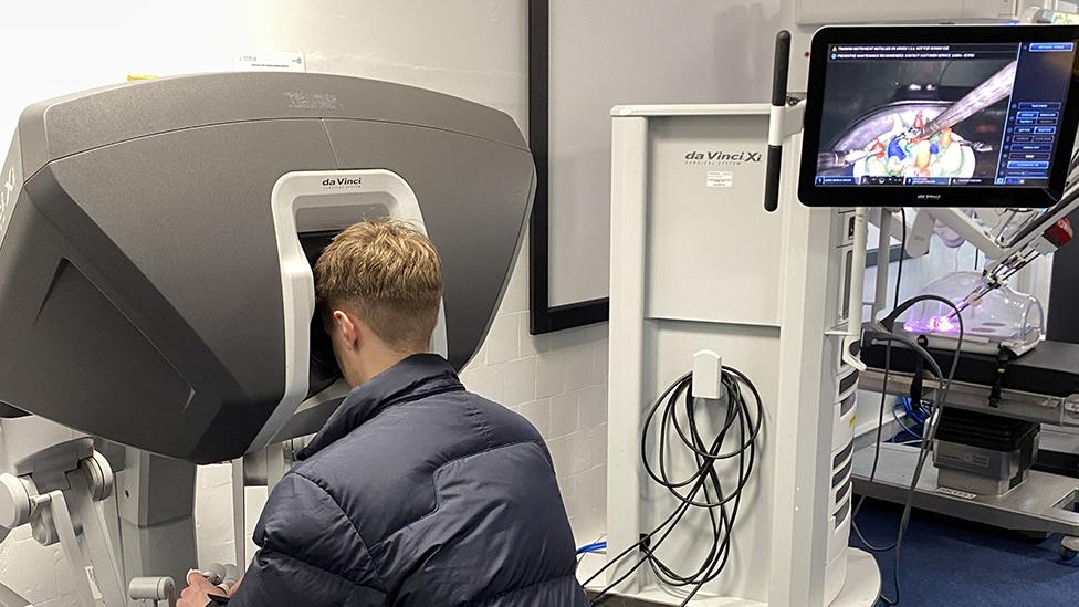 Person trying out the robot surgery simulator