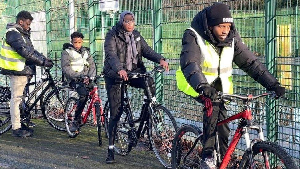 A group of young people cycling