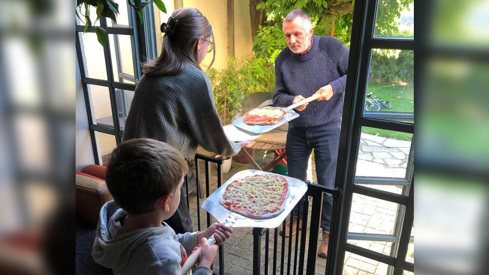 Yuliia, Matvii and Simon making homemade pizza