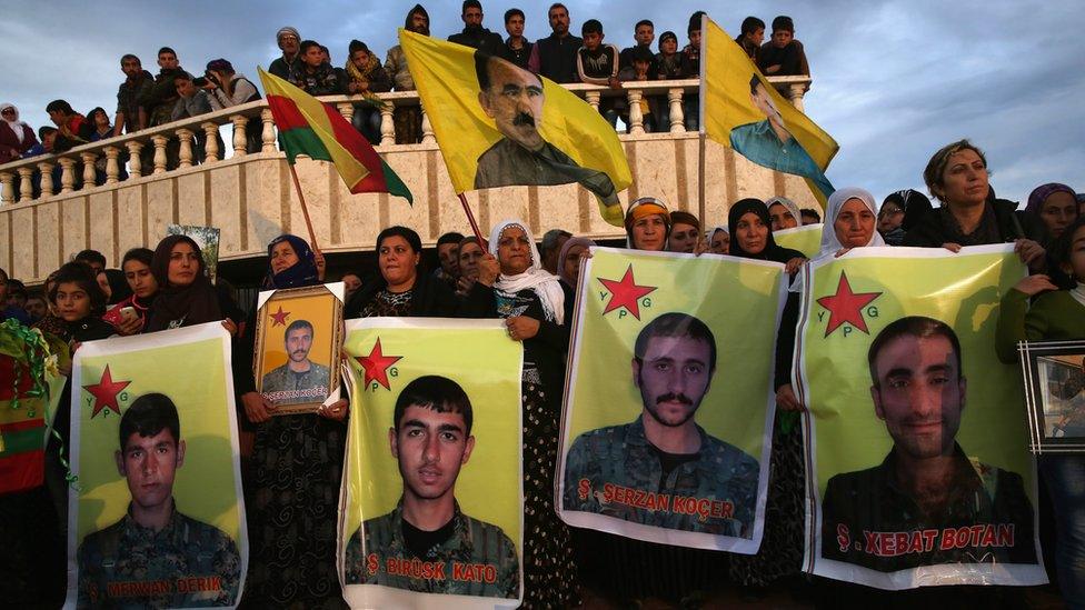 Family members and comrades attend the funeral of eight members of the Popular Protection Units (YPG) in Derek, Syria (8 November 2015). One flag in the background shows PKK founder Abdullah Ocalan