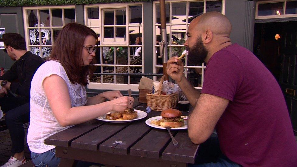 People eating fish and chips in a pub opposite Borough Market