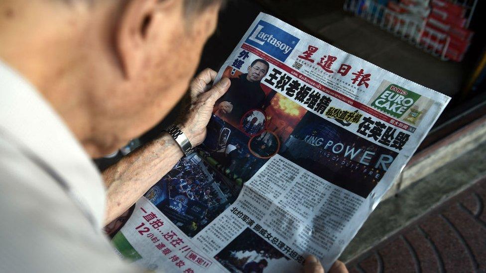 Man reading Thai newspaper