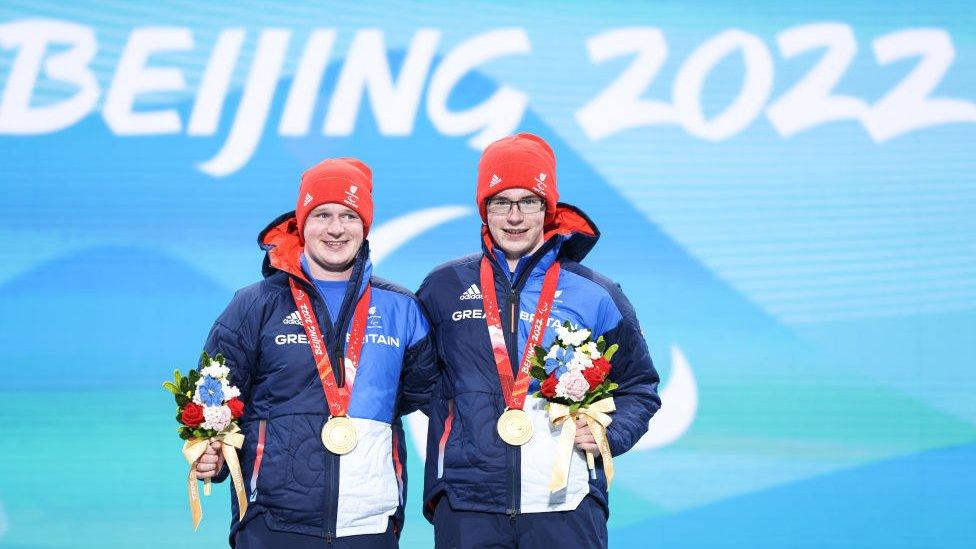 Neil Simpson and his brother Andrew collecting their gold medals.
