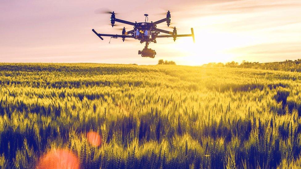 a drone with a camera over fields