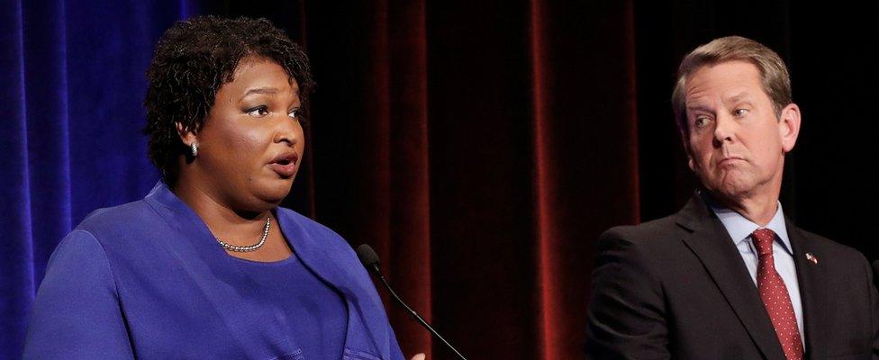 Democratic gubernatorial candidate for Georgia Stacey Abrams speaks as Republican candidate Brian Kemp looks on