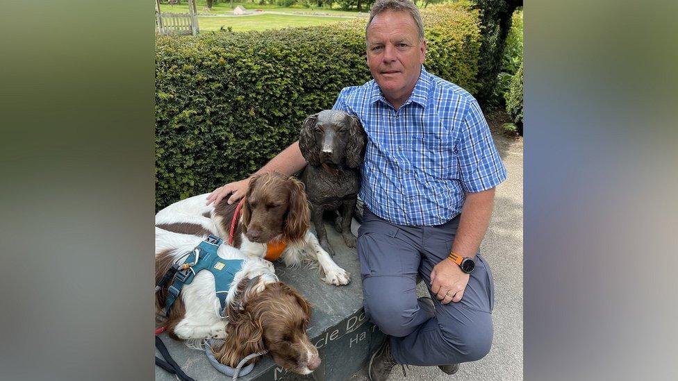 Kerry Irving with Paddy and Harry next to the statue of Max in Keswick's Hope Park