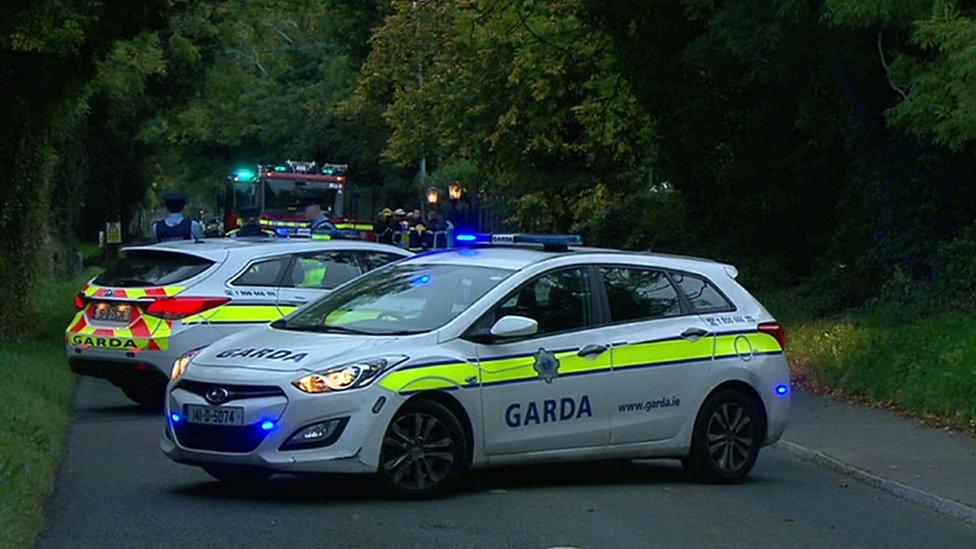 Police cars and a fire engine at the scene of the fire