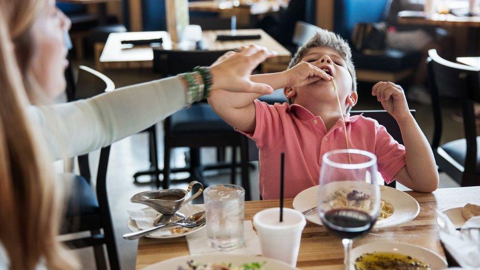 A child making a mess in a restaurant