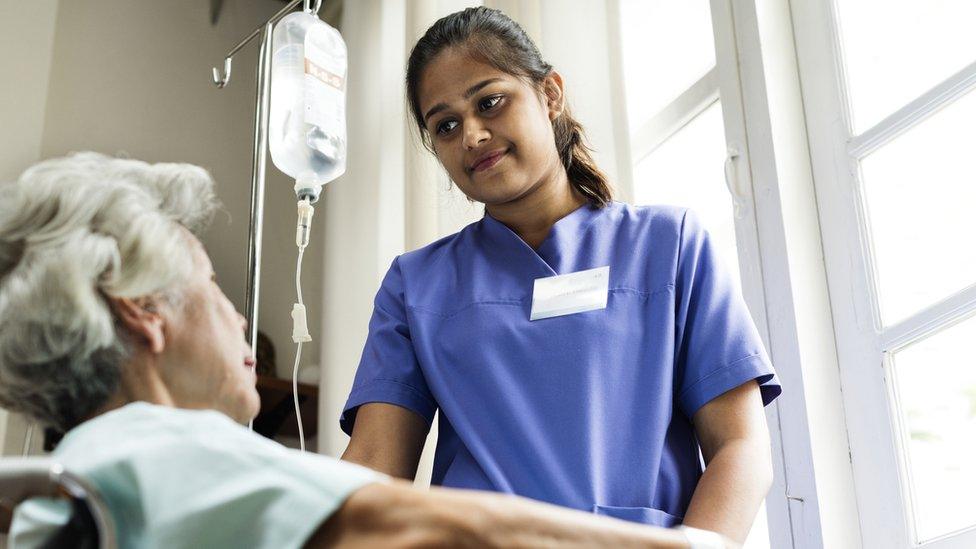 Elderly woman being treated in hospital