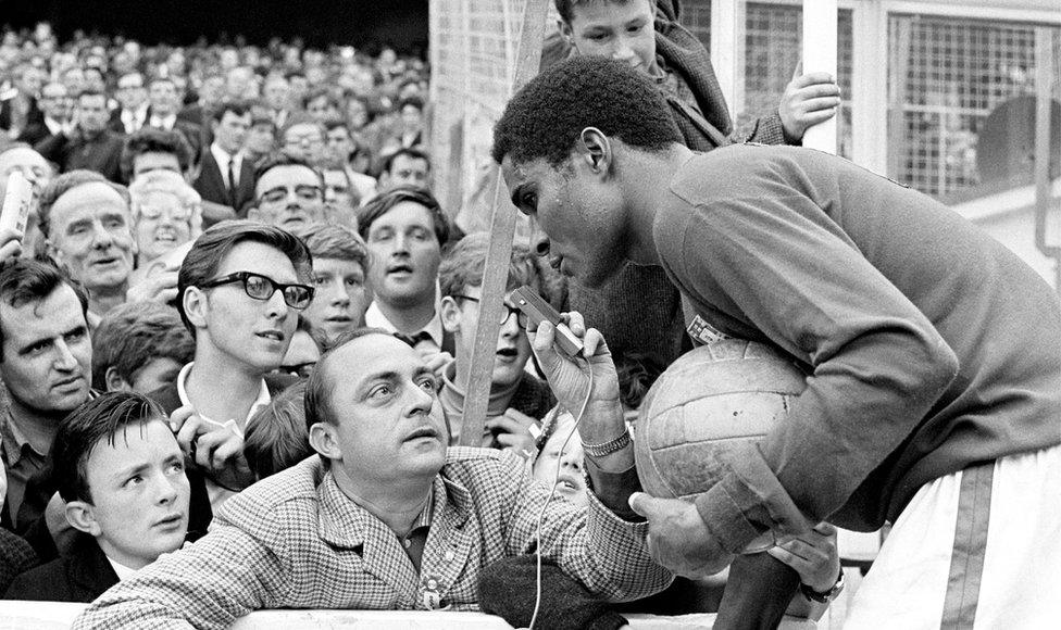 Portugal's Eusebio giving an impromptu pitchside interview at the game against North Korea at Goodison Park