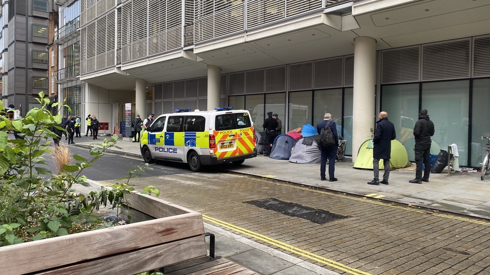 Image showing a police van parked on the street, with multiple officers present