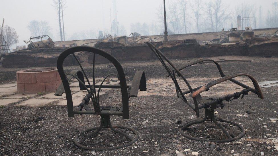 Home foundations and skeletons of possessions are all that remain in parts of a residential neighborhood destroyed by the wildfire (07 May 2016)