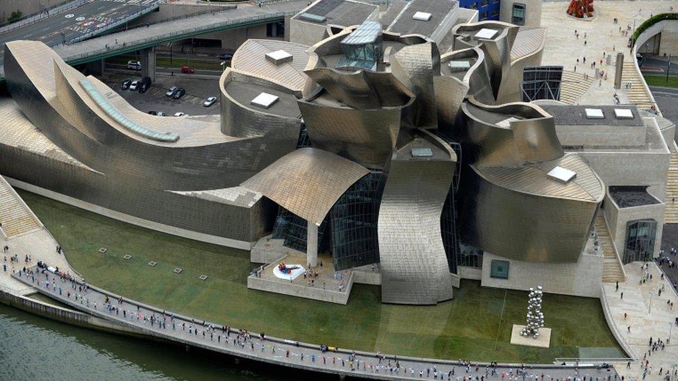 People join hands to form a human chain in front of the Guggenheim Museum in Bilbao, Spain, 10 June 2018